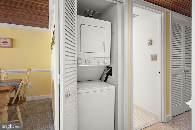 11400 Coastal Hwy Unit 8G, Ocean City, MD 21842 - laundry area featuring stacked washer / drying machine, baseboards, and carpet