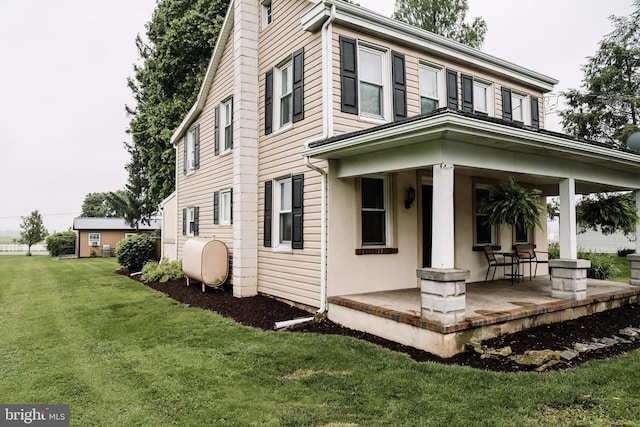 1806 Brunnerville Rd, Lititz, PA 17543 - view of side of home featuring a porch, oil tank, and a lawn