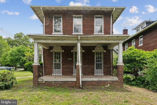 4100 Jenifer St NW, Washington, DC 20015 - view of front of home featuring a porch, brick siding, and a front lawn