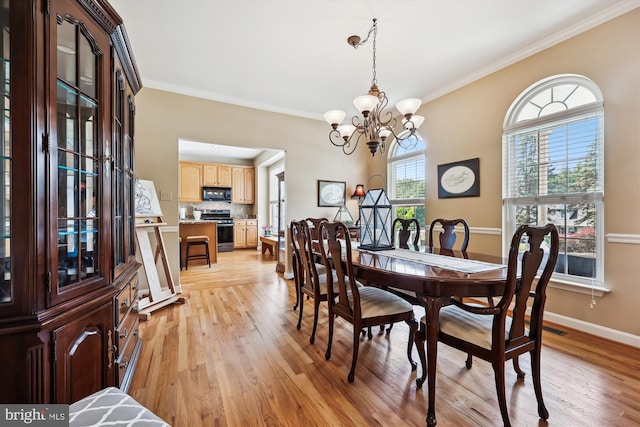 24830 Showbarn Cir, Damascus, MD 20872 - dining area featuring ornamental molding, a chandelier, light wood finished floors, and baseboards