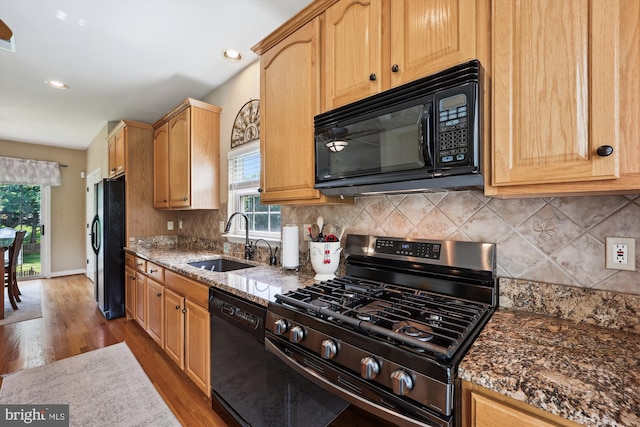 24830 Showbarn Cir, Damascus, MD 20872 - kitchen with black appliances, a sink, wood finished floors, decorative backsplash, and recessed lighting