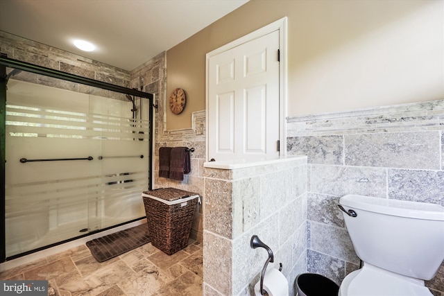 24830 Showbarn Cir, Damascus, MD 20872 - bathroom featuring tile walls, a shower stall, wainscoting, and toilet