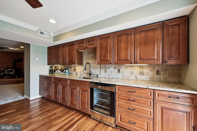 24830 Showbarn Cir, Damascus, MD 20872 - kitchen with wine cooler, a sink, a wood stove, light wood-style floors, and ceiling fan