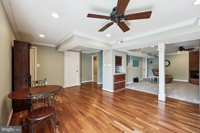 24830 Showbarn Cir, Damascus, MD 20872 - living area featuring ceiling fan, light wood-style floors, a brick fireplace, ornamental molding, and recessed lighting