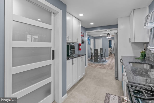 827 W 2nd St, Florence, NJ 08518 - kitchen with white cabinetry, a ceiling fan, freestanding refrigerator, dark stone countertops, and recessed lighting