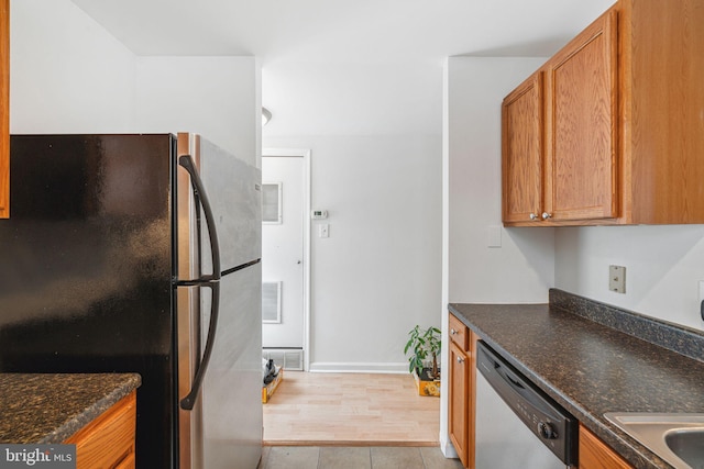 909 S 20th St Unit 3, Philadelphia, PA 19146 - kitchen featuring appliances with stainless steel finishes, brown cabinetry, baseboards, and light tile patterned floors