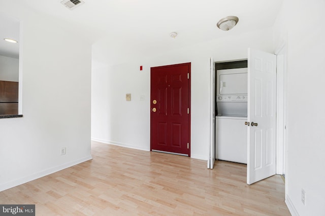 909 S 20th St Unit 3, Philadelphia, PA 19146 - unfurnished room featuring stacked washer / drying machine, light wood-style flooring, and baseboards