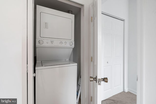 909 S 20th St Unit 3, Philadelphia, PA 19146 - washroom featuring estacked washer and dryer, carpet flooring, and baseboards