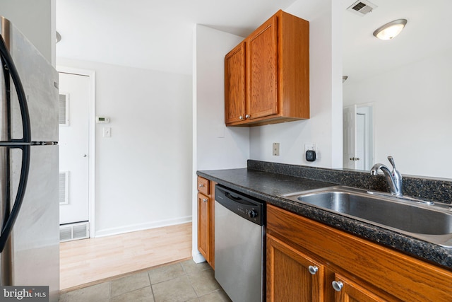 909 S 20th St Unit 3, Philadelphia, PA 19146 - kitchen featuring stainless steel appliances, a sink, dark countertops, and brown cabinetry