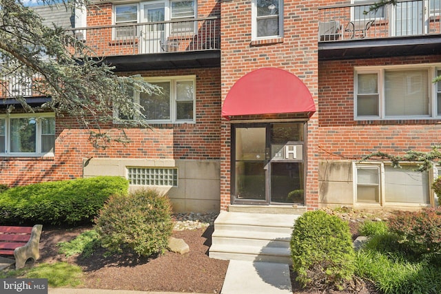 6901 Valley Ave Unit H2, Philadelphia, PA 19128 - view of exterior entry featuring brick siding and a balcony