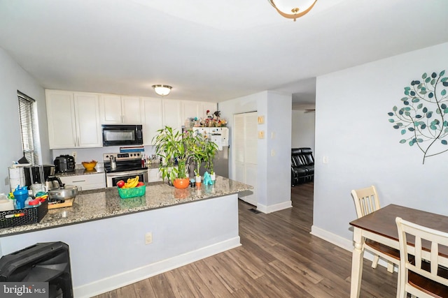 386 Braddock Rd, Smyrna, DE 19977 - kitchen featuring stainless steel appliances, white cabinets, dark wood-type flooring, light stone counters, and baseboards