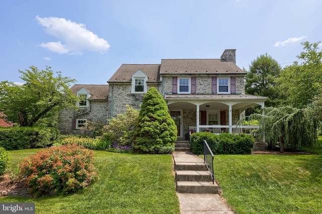 2700 Cumberland Ave, Reading, PA 19606 - view of front of home featuring stone siding, a front yard, a chimney, and a porch