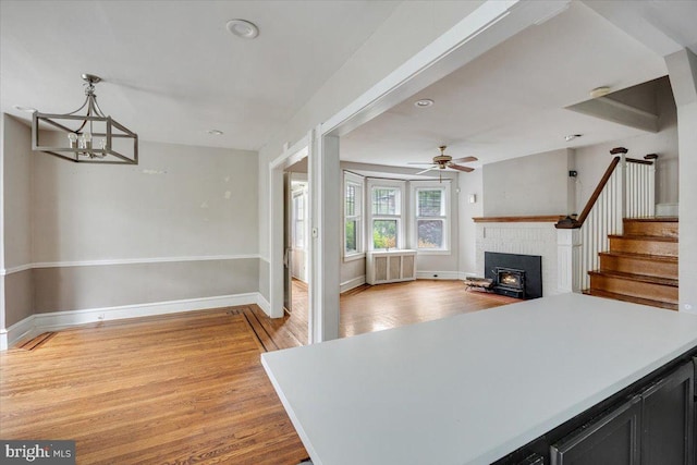 344 Clearbrook Ave, Lansdowne, PA 19050 - kitchen featuring light wood-style floors, dark cabinets, light countertops, baseboards, and a chandelier