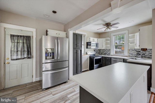 344 Clearbrook Ave, Lansdowne, PA 19050 - kitchen featuring appliances with stainless steel finishes, tasteful backsplash, a ceiling fan, and white cabinetry