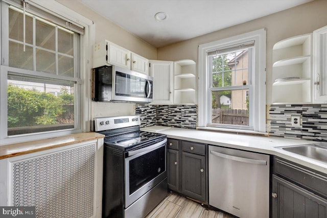 344 Clearbrook Ave, Lansdowne, PA 19050 - kitchen featuring open shelves, appliances with stainless steel finishes, white cabinets, light countertops, and backsplash