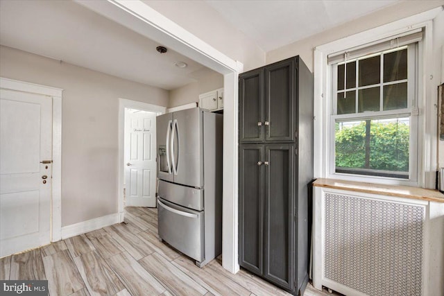 344 Clearbrook Ave, Lansdowne, PA 19050 - kitchen with stainless steel refrigerator with ice dispenser, radiator heating unit, baseboards, light wood-style floors, and dark cabinets