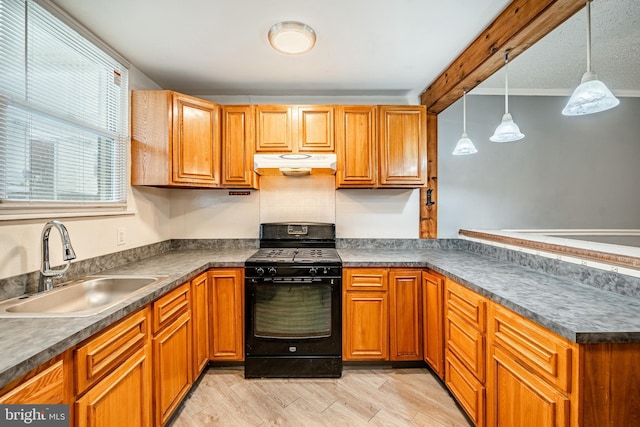 4749 Marple St, Philadelphia, PA 19136 - kitchen with black range with gas stovetop, under cabinet range hood, a sink, dark countertops, and a peninsula
