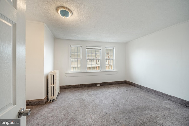 4749 Marple St, Philadelphia, PA 19136 - empty room featuring radiator heating unit, carpet flooring, a textured ceiling, baseboards, and crown molding