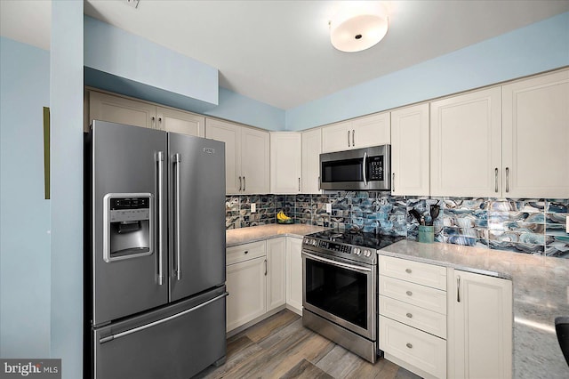 39724 E Sun Dr Unit 226, Fenwick Island, DE 19944 - kitchen featuring appliances with stainless steel finishes, wood finished floors, and decorative backsplash