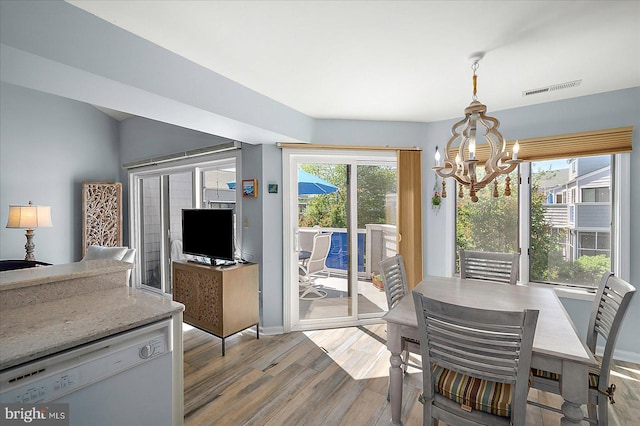 39724 E Sun Dr Unit 226, Fenwick Island, DE 19944 - dining area featuring a chandelier, wood finished floors, and baseboards