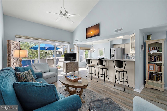 39724 E Sun Dr Unit 226, Fenwick Island, DE 19944 - living room with high vaulted ceiling, plenty of natural light, light wood-style flooring, a ceiling fan, and baseboards