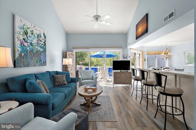 39724 E Sun Dr Unit 226, Fenwick Island, DE 19944 - living area featuring wood finished floors, a chandelier, a ceiling fan, and high vaulted ceiling