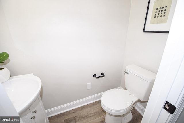 2116 E Hoffman St, Baltimore, MD 21213 - half bathroom featuring wood finished floors and vanity