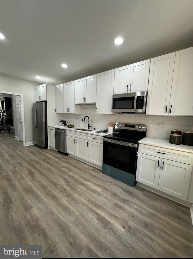 2116 E Hoffman St, Baltimore, MD 21213 - kitchen with appliances with stainless steel finishes, light countertops, light wood-type flooring, and recessed lighting