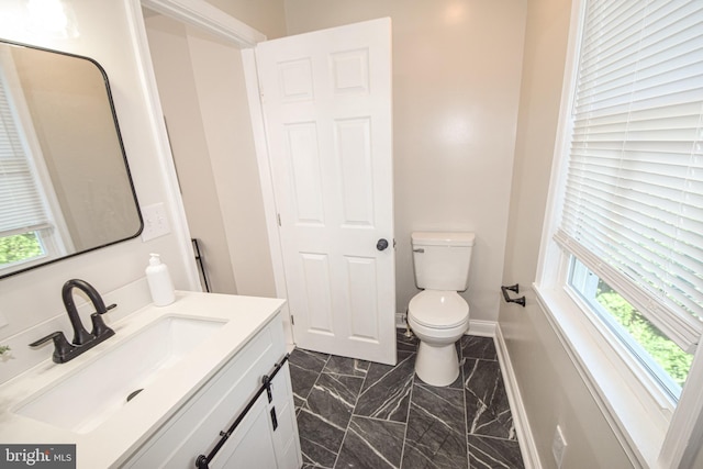 2116 E Hoffman St, Baltimore, MD 21213 - bathroom featuring plenty of natural light, vanity, and marble finish flooring
