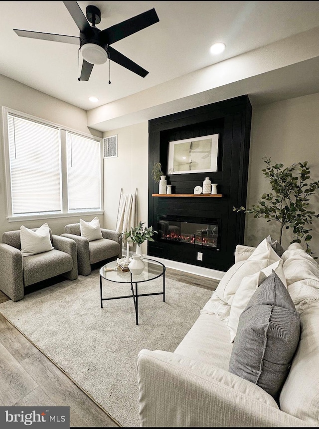 2116 E Hoffman St, Baltimore, MD 21213 - living room featuring wood finished floors, a ceiling fan, recessed lighting, and a glass covered fireplace