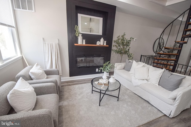 2116 E Hoffman St, Baltimore, MD 21213 - living area featuring wood finished floors, stairs, and a large fireplace