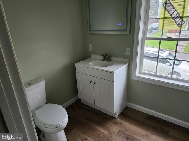 51 Maple St, Cumberland, MD 21502 - half bath featuring vanity, toilet, wood finished floors, and baseboards