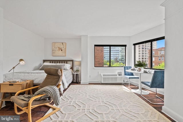 1825 T St NW Unit 701, Washington, DC 20009 - bedroom featuring wood finished floors, baseboards, and a wall mounted air conditioner