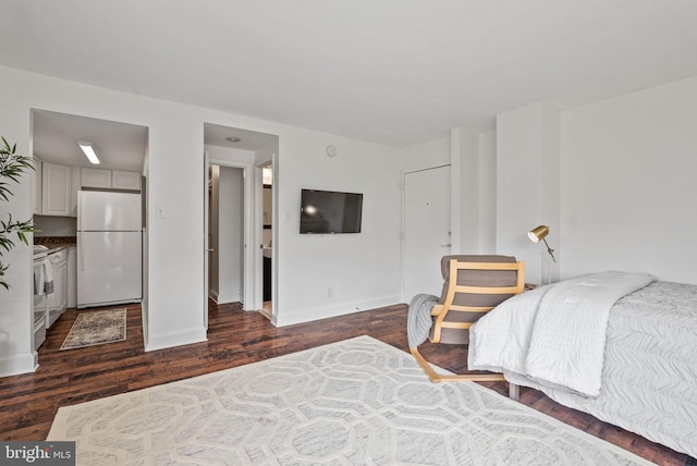 1825 T St NW Unit 701, Washington, DC 20009 - bedroom with freestanding refrigerator, dark wood finished floors, and baseboards