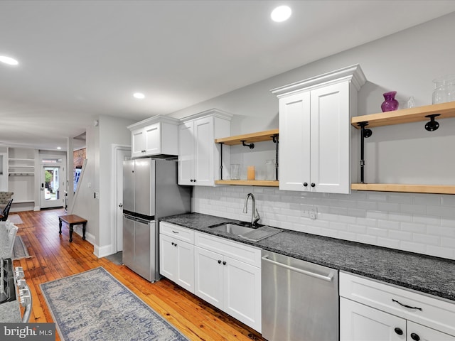 546 N Plum St, Lancaster, PA 17602 - kitchen featuring open shelves, appliances with stainless steel finishes, a sink, white cabinets, and decorative backsplash
