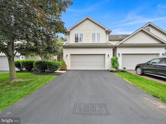 1082 Stillwood Cir, Lititz, PA 17543 - view of front facade featuring stucco siding, driveway, and a front yard