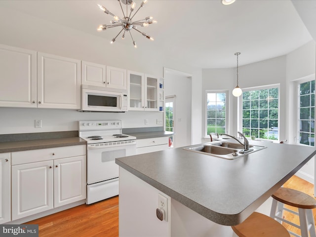 1082 Stillwood Cir, Lititz, PA 17543 - kitchen featuring white appliances, dark countertops, white cabinets, and light wood-style flooring