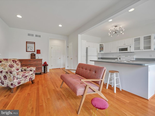 1082 Stillwood Cir, Lititz, PA 17543 - living area featuring light wood finished floors, recessed lighting, and a chandelier
