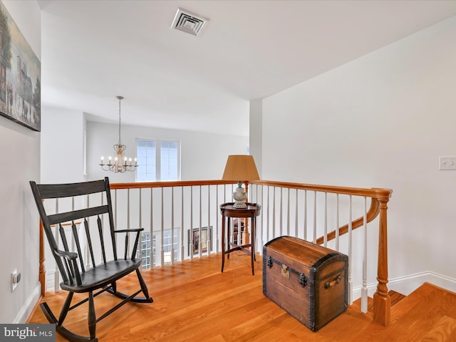 1082 Stillwood Cir, Lititz, PA 17543 - living area featuring a chandelier, wood finished floors, and an upstairs landing