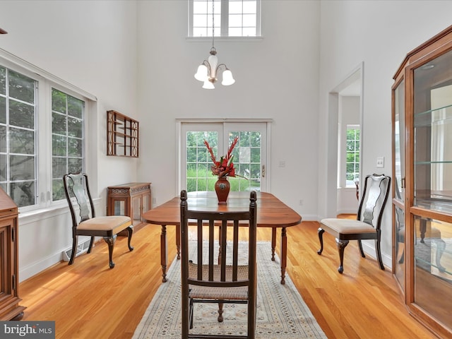 1082 Stillwood Cir, Lititz, PA 17543 - dining space with a chandelier, a high ceiling, and light wood-style floors