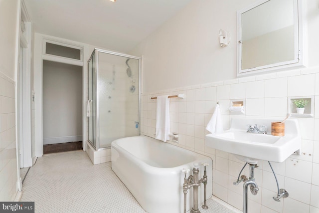 2638 E Baltimore St, Baltimore, MD 21224 - full bathroom with a soaking tub, tile walls, and a shower stall