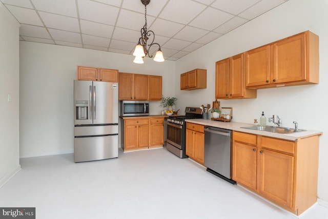 2638 E Baltimore St, Baltimore, MD 21224 - kitchen with appliances with stainless steel finishes, a sink, a drop ceiling, pendant lighting, and light countertops