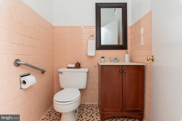 2638 E Baltimore St, Baltimore, MD 21224 - half bathroom featuring tile walls, vanity, toilet, and tile patterned flooring