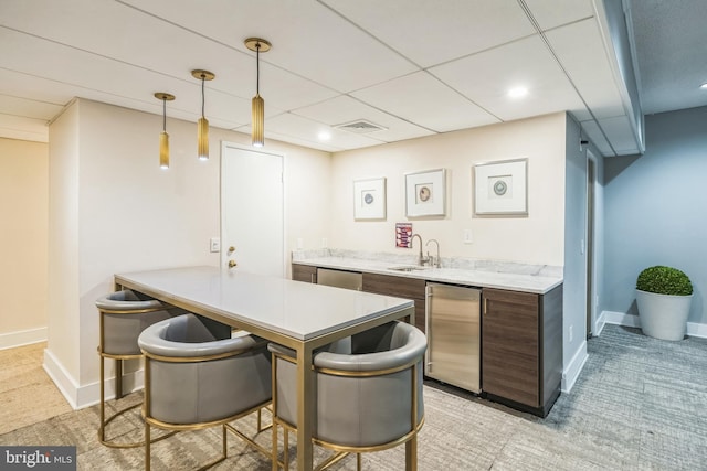 6101 Edsall Rd Unit 702, Alexandria, VA 22304 - indoor wet bar featuring refrigerator, dishwasher, light carpet, hanging light fixtures, and baseboards