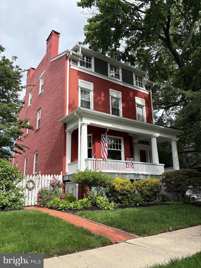212 S Union Ave, Havre De Grace, MD 21078 - view of front of property featuring a porch, a chimney, and brick siding