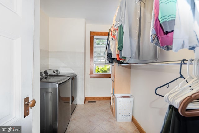 212 S Union Ave, Havre De Grace, MD 21078 - laundry room with washing machine and clothes dryer, light tile patterned flooring, and baseboards