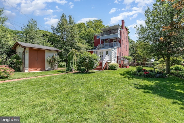 212 S Union Ave, Havre De Grace, MD 21078 - rear view of property with a balcony, a chimney, and a lawn