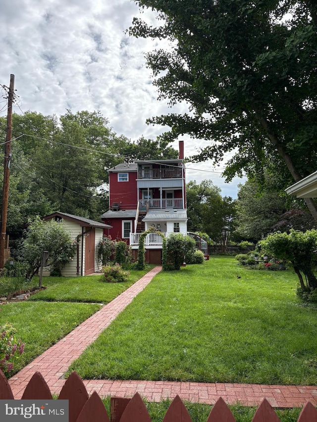 212 S Union Ave, Havre De Grace, MD 21078 - view of front of house featuring a chimney, a front yard, and a balcony