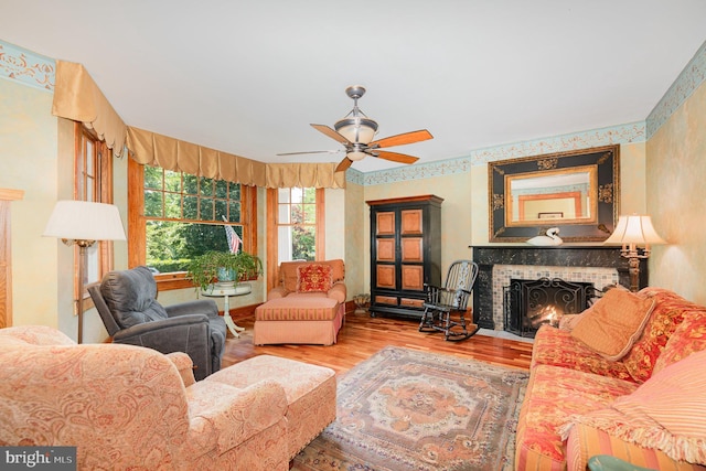 212 S Union Ave, Havre De Grace, MD 21078 - living room with wood finished floors, a brick fireplace, and a ceiling fan