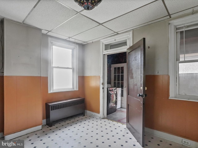 16 Avalon Ave, Hagerstown, MD 21740 - unfurnished room featuring radiator heating unit, washing machine and dryer, a paneled ceiling, light floors, and a wainscoted wall